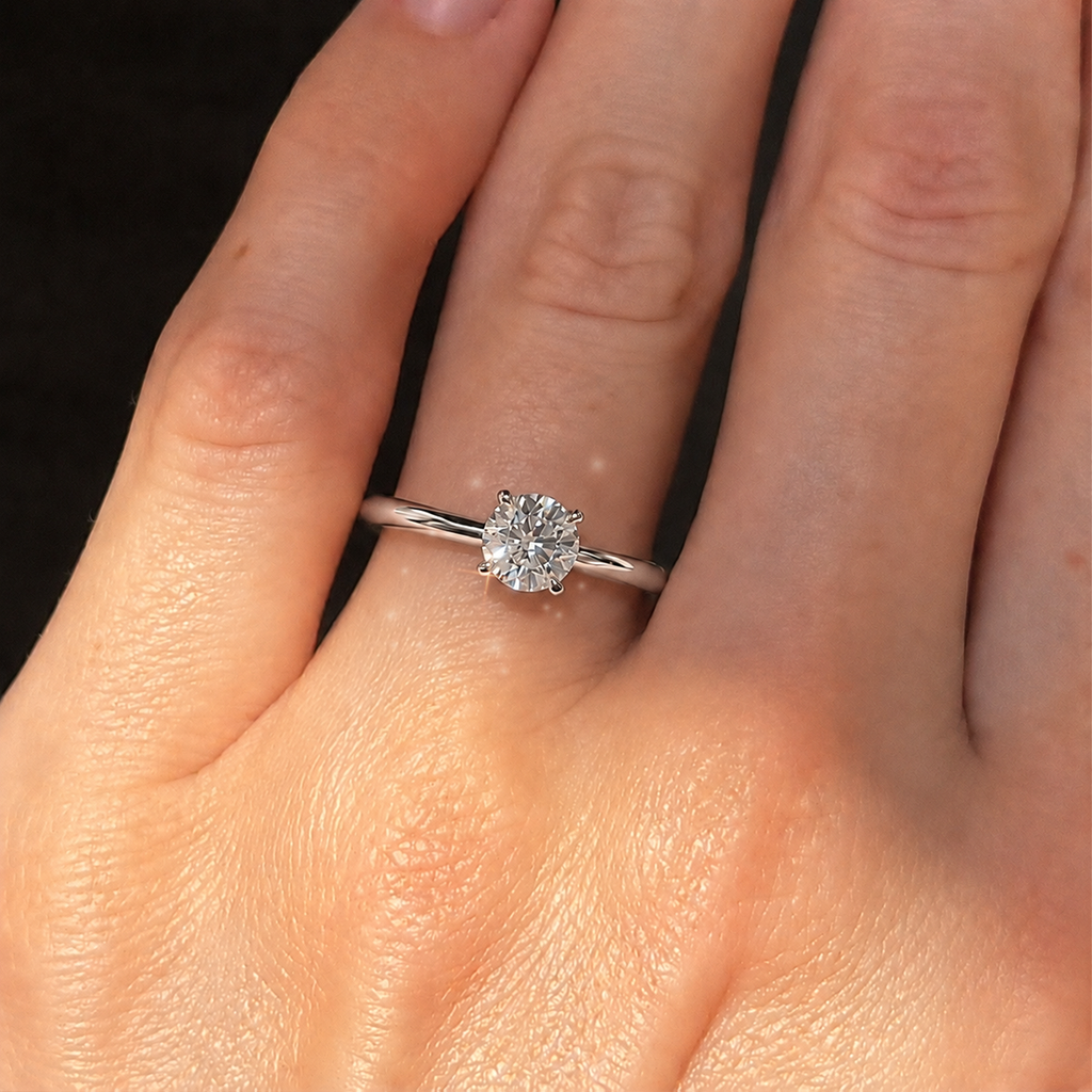 Four-prong round solitaire engagement ring, moissanite stone in 18K White Gold Vermeil
