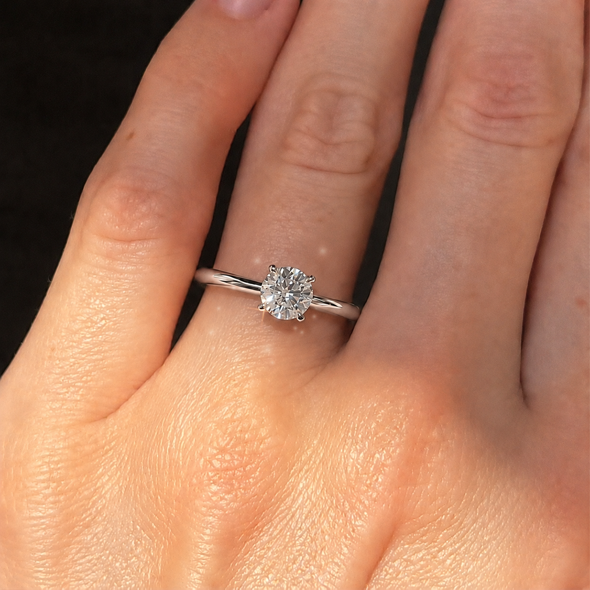 Four-prong round solitaire engagement ring, moissanite stone in 18K White Gold Vermeil